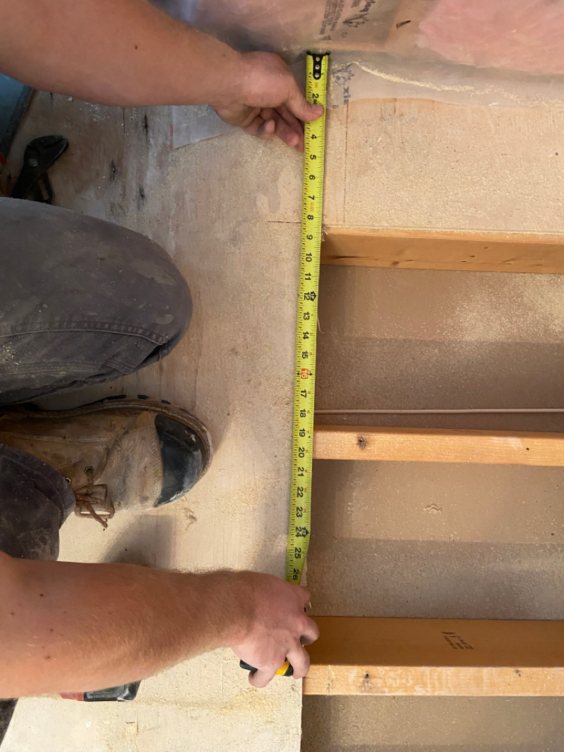 a man measuring a floor for renovations